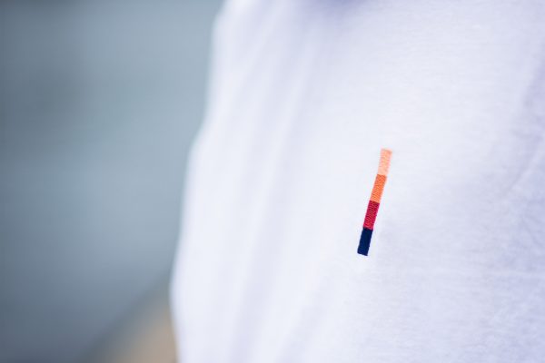 Close up look at the dusk logo embroided on a t-shirt
